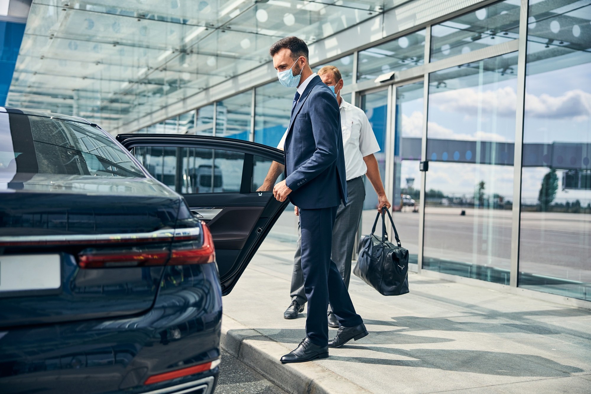 Handsome businessman taking taxi at the airport Handsome businessman taking taxi at the airport